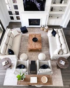 an aerial view of a living room with couches, tables, and fireplaces