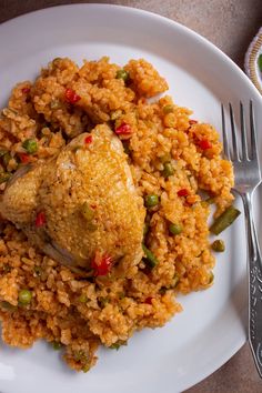 a white plate topped with rice and chicken