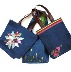 These handmade, stylish, modern, and sturdy upcycled denim tote bags are a head turner . Very unique, summery, casual bag with a modern touch. Functional totes with features such as zipper, magnetic closure, inside pockets, waterproof lining. Comes in various styles. Please read the full description for exact details of each individual bag. Key Features -------------- - Upcycled from excess denim fabric otherwise destined for landfills. Good for the earth! - Stylish and sturdy denim tote bag gre Handmade Denim Blue Bag For Daily Use, Handmade Denim Bags For Everyday Use, Everyday Handmade Denim Bag, Embroidered Denim Bags For Everyday Use, Handmade Denim Blue Rectangular Bag, Handmade Denim Blue Cotton Bag, Handmade Multicolor Embroidered Tote Shoulder Bag, Handmade Denim Blue Cotton Shoulder Bag, Casual Embroidered Denim Bag