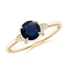 a yellow gold ring with an oval blue sapphire and diamonds