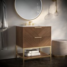 a bathroom vanity with a round mirror above it and towels stacked on the bottom shelf