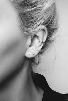 black and white photograph of woman with ear piercings