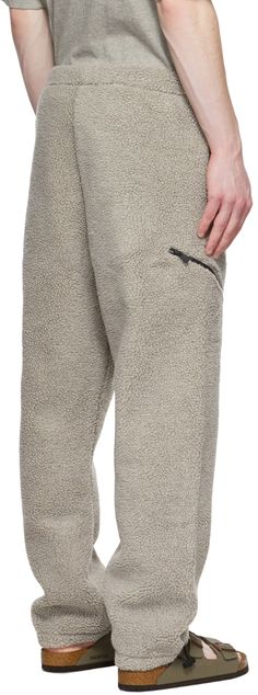 Sherpa fleece lounge pants. · Drawstring at elasticized waistband · Rubberized logo patch at front · Gusset at dropped inseam · Zip pockets · Two-pocket styling · Bungee-style drawstring at elasticized cuffs · Fully polyester mesh lining Please note that this item may not be shipped within the EU. Supplier color: Dark oatmeal Grey Lounge, Fear Of God Essentials, Clothing Pants, Fear Of God, Mens Essentials, Sherpa Fleece, Drawstring Pants, Lounge Pants, Leg Warmers