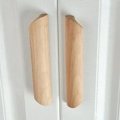 two wooden handles on a white door