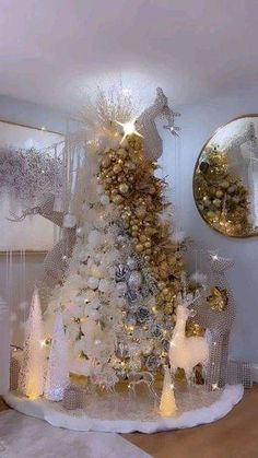 a white christmas tree with gold and silver decorations