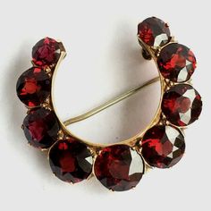 American Antique Edwardian/ post Gilded Age 14K Rosi Yellow Gold Brooch circa 1900s, nine pieces of Old European Cut Natural Pyrope Garnet 6.5 mm to 9 mm in excellent condition considering 100 Yrs of age, approximate size of 1 1/4 inch by 1 3/4 inch American Antique Edwardian 14K Rosi' Yellow Gold Natural Pyrope Garnet Brooch  Measurements; 1.25 inch by 1.75 inch Stones; Pyrope Garnet, Old European Cut in excellent condition, no abrasion, damage. chips or cracks (see pictures) Hallmark; none  Qu Pyrope Garnet, American Antiques, Gold Brooch, Gilded Age, Gold Brooches, Rose Yellow, Vintage Watches, Antique Jewelry, Vintage Antiques