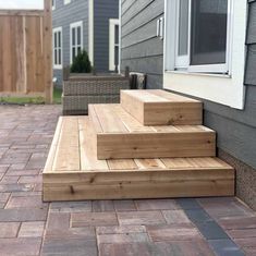 the steps are made out of wood and have been placed on the side of the house