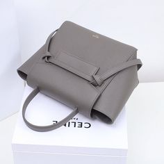 Size: 20cm*20cm*10cm It comes with Dust box, Care manual, Tag, and Paper bag. Designer Gray Rectangular Shoulder Bag, Modern Square Bucket Bag As Gift, Chic Gray Shoulder Bag With Dust Bag, Chic Square Bucket Bag As Gift, Modern Gray Shoulder Bag With Top Carry Handle, Modern Double Handle Box Bag For Gift, Modern Double Handle Box Bag As Gift, Modern Gray Square Shoulder Bag, Modern Gray Bags With Detachable Handle