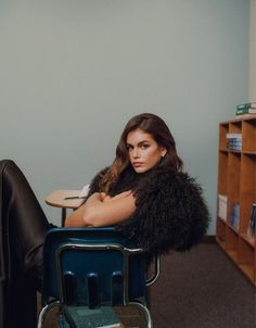 a woman sitting in a chair with her legs crossed