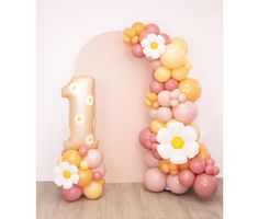 balloons are arranged in the shape of numbers one and two, with flowers on them