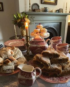 a table topped with plates and cups filled with food