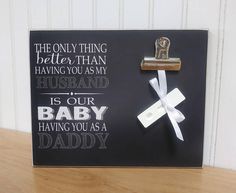 a black and white sign with a cross on it that says, the only thing better than having you as my husband is our baby having you as a daddy