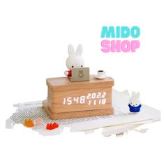 a wooden box with a rabbit on it and the words mido shop above it