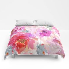 a bed with pink and red flowers on it