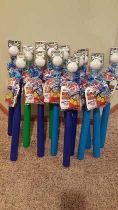 several plastic toothbrushes are lined up in front of each other on the floor