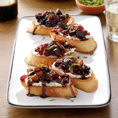 toasted breads with cranberry sauce and whipped cream on a white plate