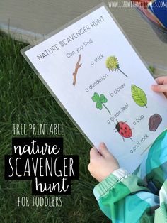 a child holding up a nature scavenger hunt for toddlers to print out