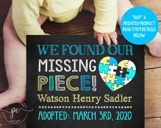 a baby is holding up a missing piece sign