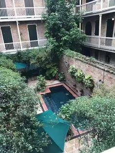 an aerial view of the courtyard and pool in this apartment building, looking down on the garden