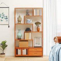 a room with a bed, bookshelf and vases