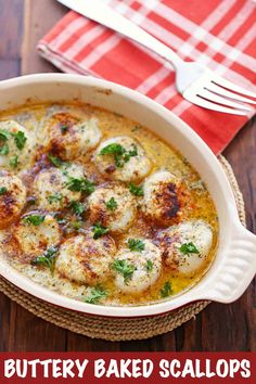 buttery baked scallops in a dish with parsley