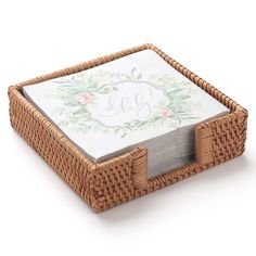 a wicker tray with a monogrammed napkin holder