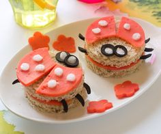 two cupcakes decorated like ladybugs on a plate