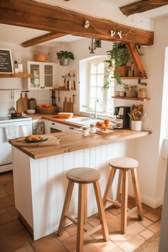 a kitchen with two stools next to an island