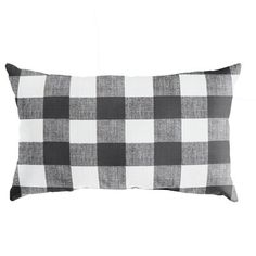 a black and white checkered pillow on a white background