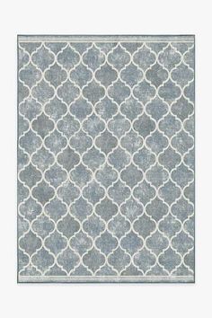 a gray and white rug with circles on it