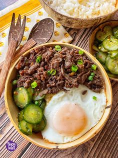 a bowl filled with meat and vegetables next to rice