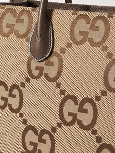 Gucci's neat rectangular tote bag is crisscrossed with the label's new maximalist take on the 'GG' monogram. It's panelled from canvas with leather through the top handles, sides and base and fitted with an optional webbing shoulder strap, too. Modern Gucci Shoulder Bag In Monogram Canvas, Gucci Rectangular Monogram Canvas Bag, Gucci Monogram Canvas Rectangular Bag, Modern Gucci Monogram Canvas Shoulder Bag, Gucci Beige Bag With Logo, Gucci Coated Canvas Bag With Logo, Gucci Rectangular Bag With Leather Handles, Modern Gucci Shoulder Bag With Logo, Designer Gucci Tote Shoulder Bag