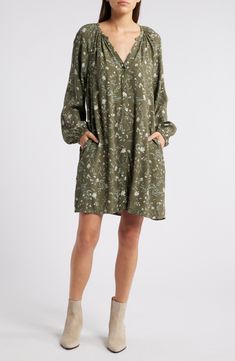 Keep it cute and kicked back in a relaxed-fit shift dress tumbled in delicate blooms. 35 1/2" length (size Medium) Front button closure V-neck Long sleeves 100% viscose Unlined Machine wash, dry flat Imported Casual Long Sleeve Green Floral Dress, Casual Green Long Sleeve Floral Dress, Spring Knee-length Rayon Shirt Dress, Knee-length Rayon Shirt Dress For Spring, Long Sleeve Relaxed Fit Floral Print Dress, Long Sleeve Floral Print Relaxed Fit Dress, Vacation V-neck Shirt Dress With Floral Print, Spring V-neck Rayon Shirt Dress, Floral Print V-neck Shirt Dress For Vacation