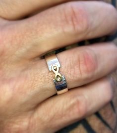 a person's hand with a ring on it