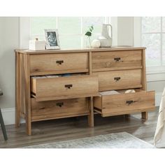 a wooden dresser with drawers in a bedroom