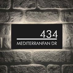 a brick wall with a sign that reads 434 mediterann fan dr