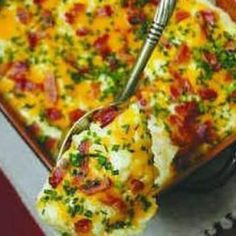 a close up of a casserole on a pan with a fork in it