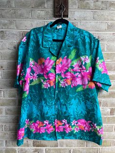 🌺tropical shirt  Buttons down front  🌺label: Royal Creation  Tag size: xxl Care: machine was  Content: polyester  No stretch  Bust:54" Waist:54" Hip:54" Length:32" Shoulder:21.5" 🌺great condition Pink Hawaiian Shirt With Tropical Print, Pink Tropical Top With Camp Collar, Pink Tropical Hawaiian Shirt With Floral Print, Pink Floral Print Tropical Hawaiian Shirt, Tropical Pink Hawaiian Shirt With Floral Print, Green Tropical Print Hawaiian Shirt, Green Hawaiian Tops With Hibiscus Print, Green Tropical Hibiscus Print Top, Green Tropical Print Camp Shirt