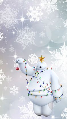 a white polar bear holding a christmas ornament in the air with snowflakes on it