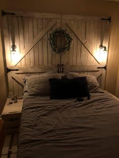 a bed with two lights on each side and a headboard made out of wood