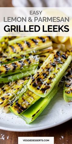 grilled leeks on a plate with lemon and parmesan cheese in the background