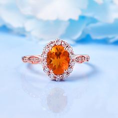 an orange and white diamond ring on a blue background