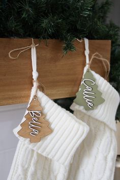 two christmas stockings hanging from a wooden hanger