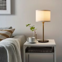 a living room with a couch, coffee table and lamp on it's side