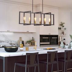 a modern kitchen with marble counter tops and bar stools in front of the island