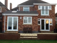 a brick house with white windows and doors