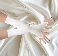 Add a touch of timeless sophistication to your wedding ensemble with our luxurious  bridal color satin gloves. Designed for the bride who desires elegance and grace, these gloves offer a flawless finish to your special day attire. Premium Quality Stretchable Satin Material Length: The length (Over the Elbow) of the gloves from the finger loop to the cuff is about 19.5 inch Fit upper arm circumference up to 12.5 inches  At an exquisite extra long, these fingerless gloves extend gracefully to acce Bride With Long Gloves, Fingerless Wedding Gloves, Wedding Gloves Fingerless, Wedding Gloves With Dress, Disco Drag, Chiffon Gloves, White Gloves Wedding, Fingerless Gloves Wedding, Wedding Disco