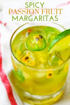 a close up of a drink in a glass with a lime slice on the rim