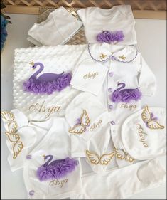 the baby's personalized onesuits are all white and purple