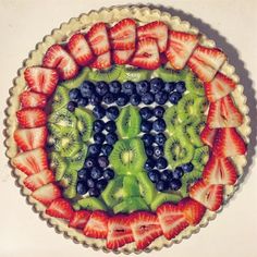 a fruit tart with kiwis, strawberries and blueberries